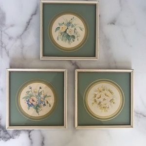 Three vintage floral watercolors framed in glass.